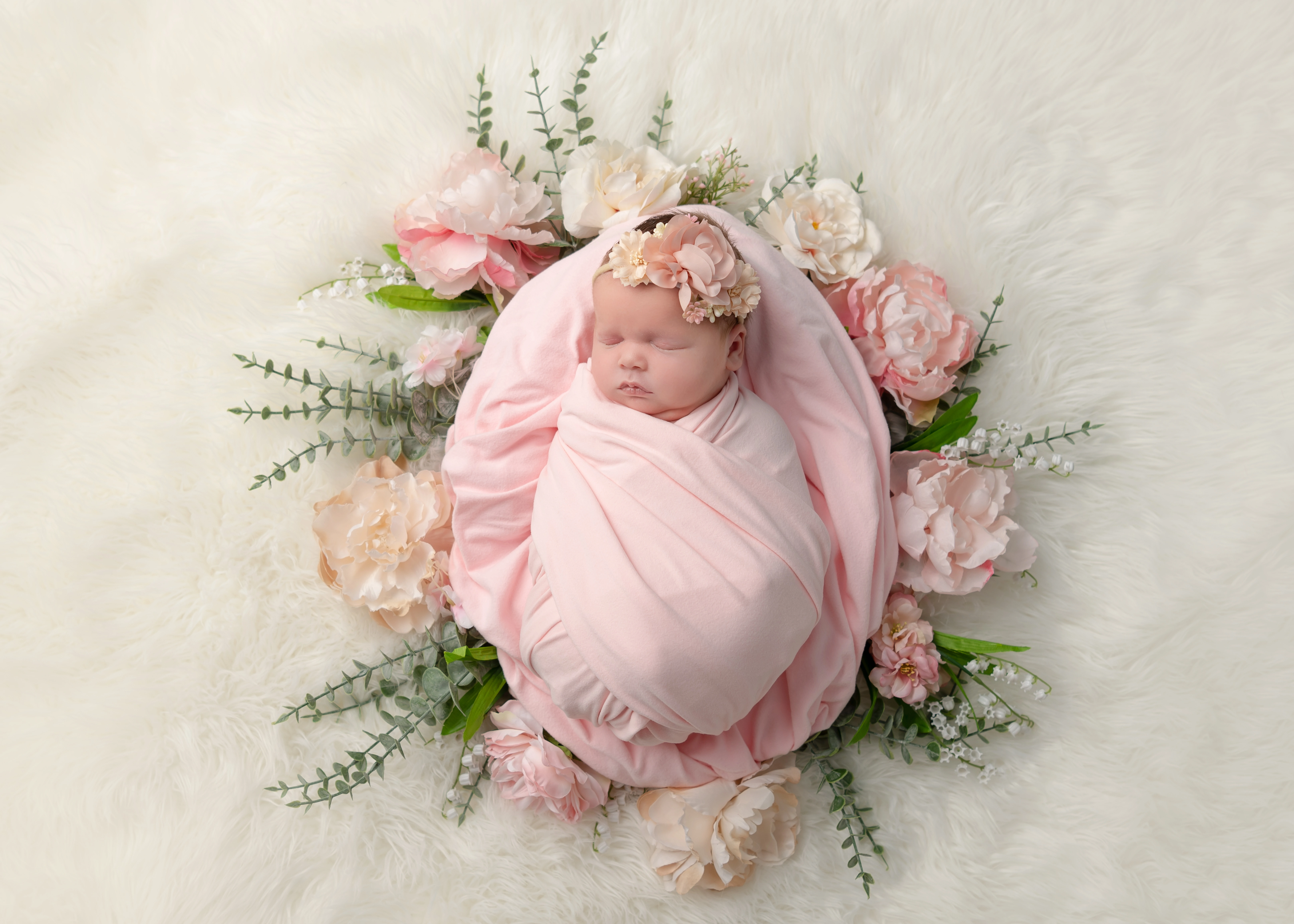 Newborn baby swaddled in pink surrounded by flowers — Magnolia Coasts Photography, Mississauga